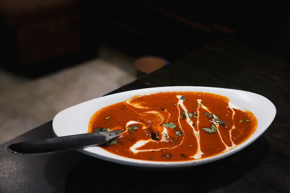 a bowl of soup with a spoon in it