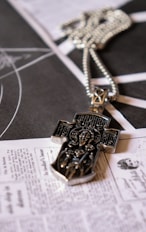 a cross is laying on top of a newspaper