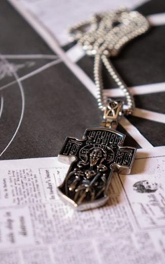 a cross is laying on top of a newspaper