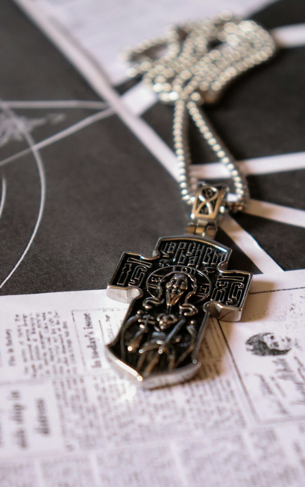 a cross is laying on top of a newspaper