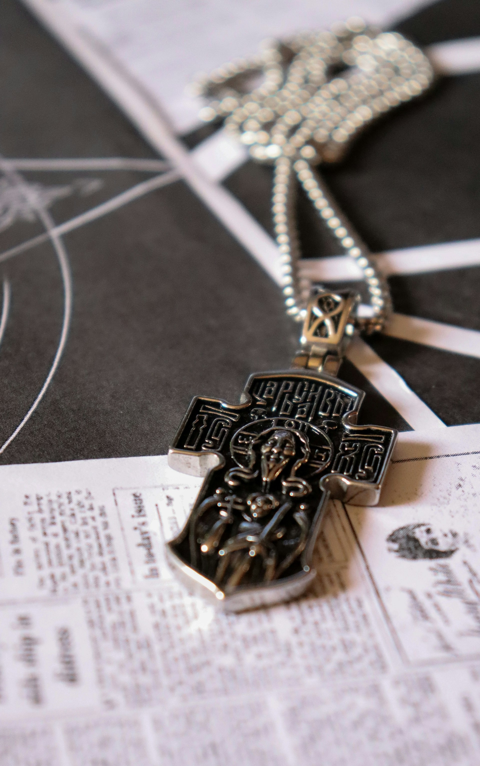 a cross is laying on top of a newspaper