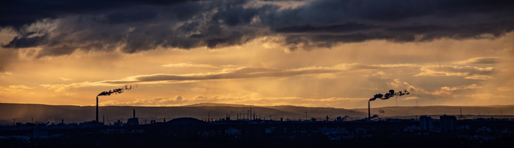 the sun is shining through the clouds over a city