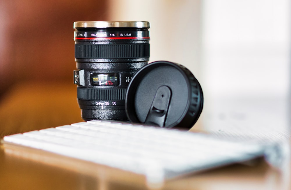 a camera lens sitting on top of a computer keyboard