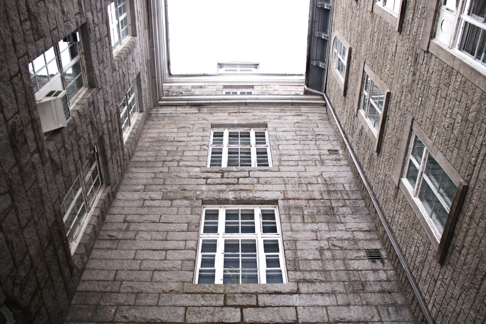 a tall brick building with windows and a skylight