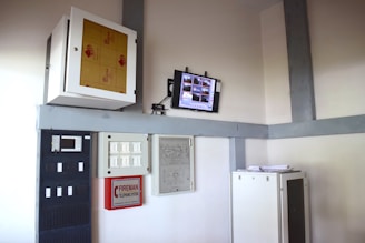 a computer monitor sitting on top of a shelf
