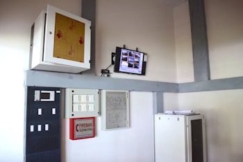 a computer monitor sitting on top of a shelf