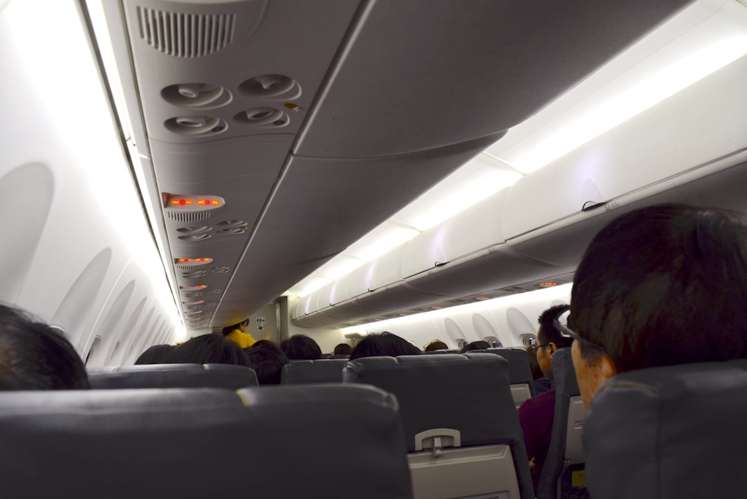 a group of people sitting on an airplane, Inside cabin of Bombadier Dash8 Q400