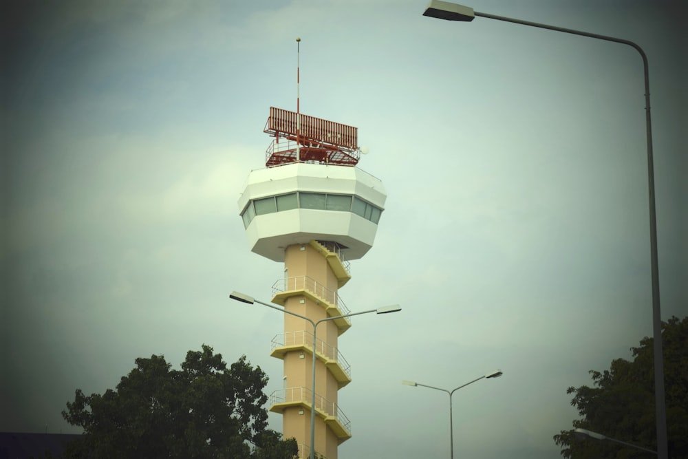 a tall tower with a red and white top