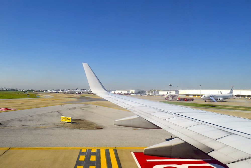 the wing of an airplane on a runway