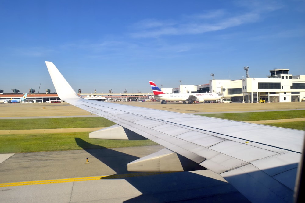 the wing of an airplane as seen from the window of another plane