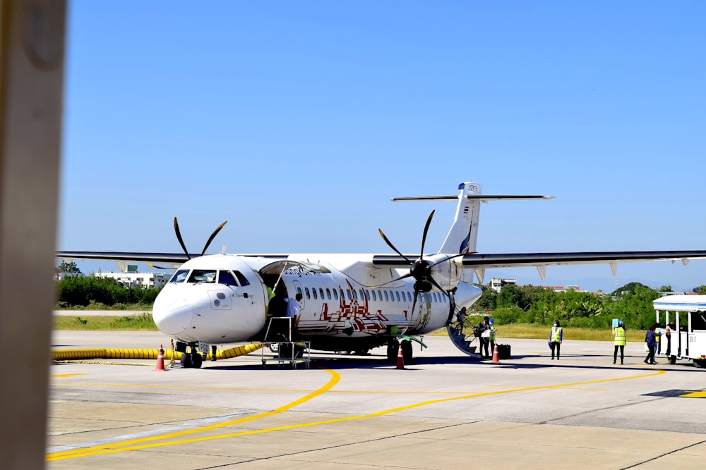 an airplane is parked on the tarmac at an airport