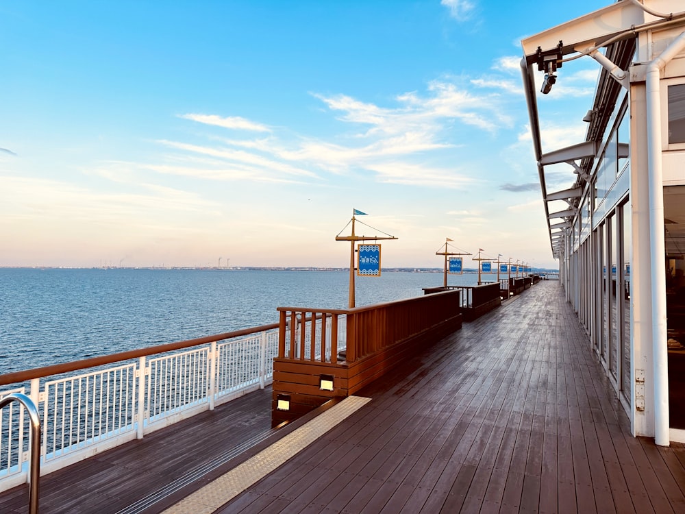 a long wooden deck with a railing and railing guardrail