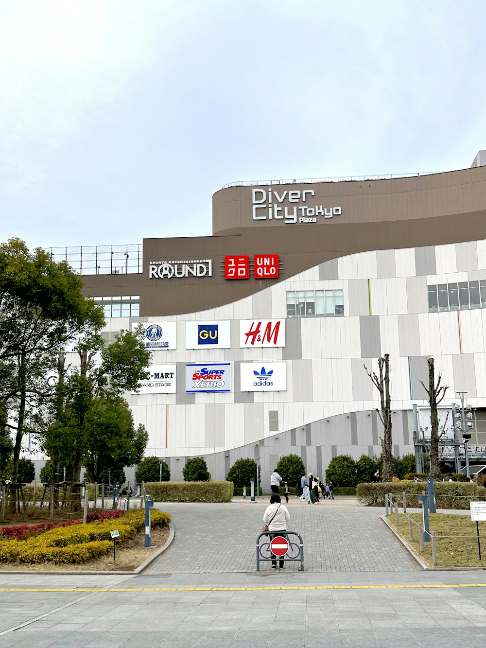 a person riding a bike in front of a building