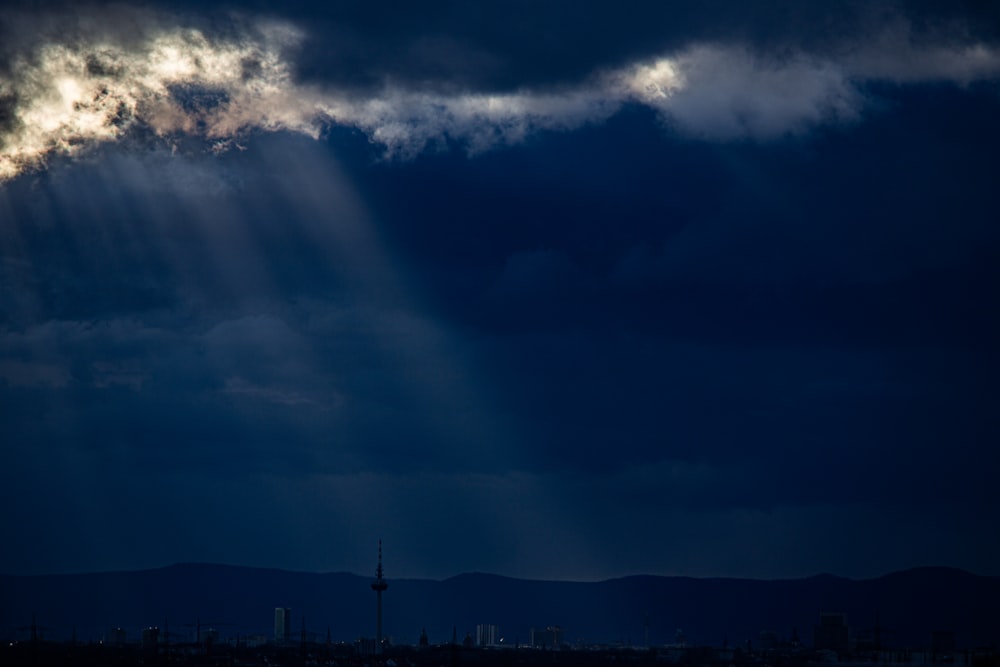 the sun shines through the clouds over a city