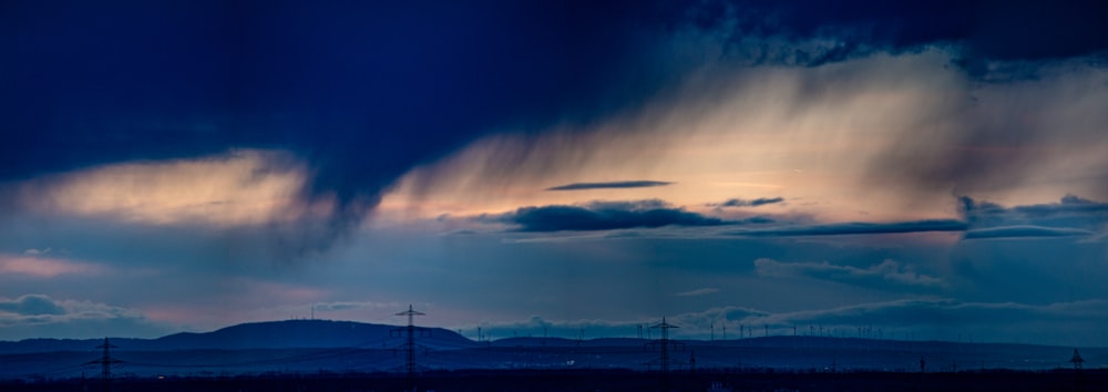 a very dark sky with some clouds in the background