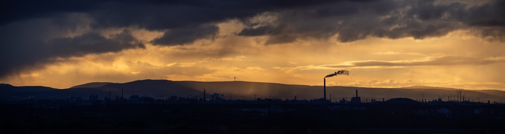 the sun is shining through the clouds over a city