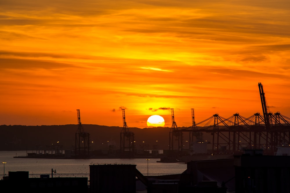 the sun is setting over a large body of water