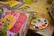 a table topped with lots of art supplies