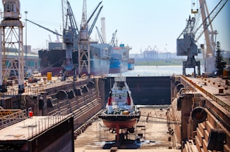 a large ship in a dry dock with other ships in the background