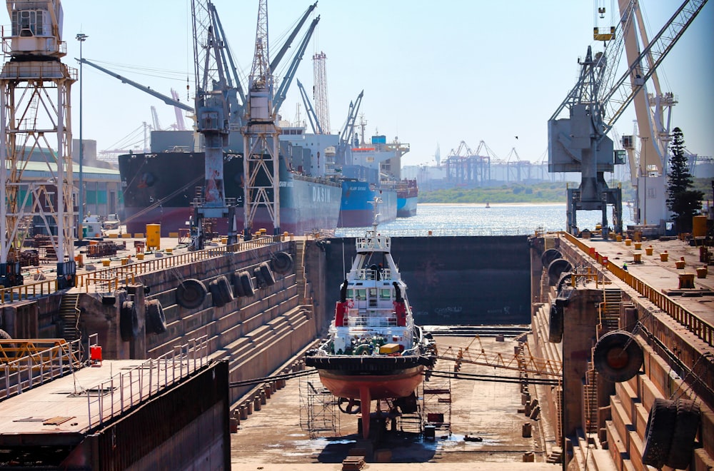 a large ship in a dry dock with other ships in the background