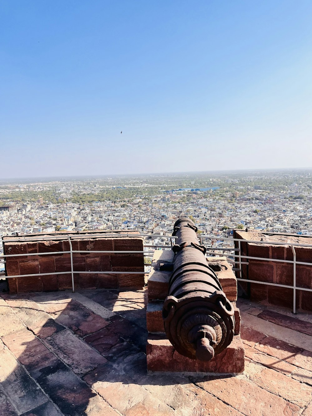 a large cannon sitting on top of a stone wall