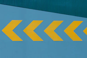 a yellow arrow painted on the side of a building
