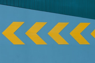 a yellow arrow painted on the side of a building