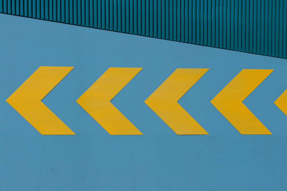 a yellow arrow painted on the side of a building