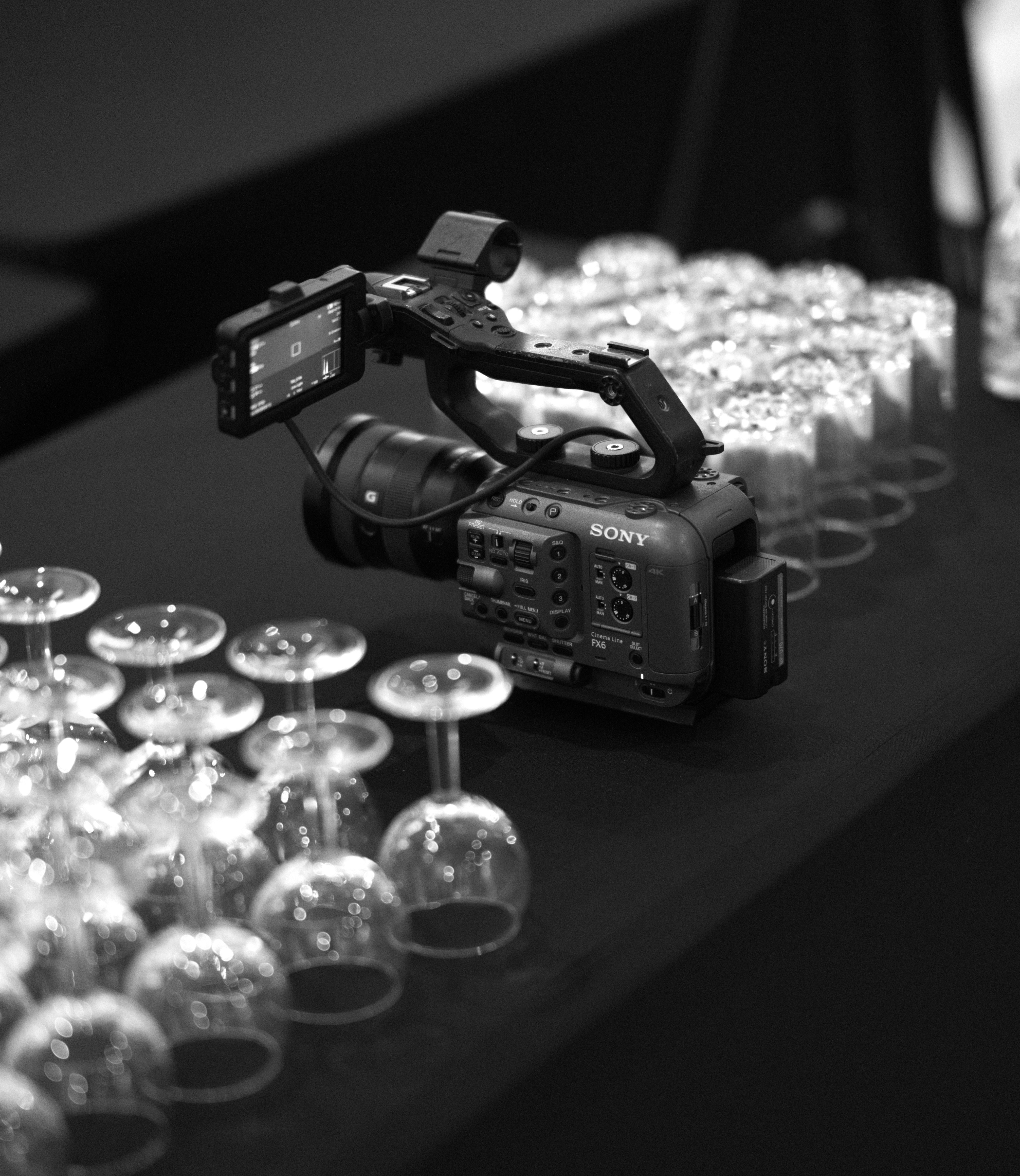 a camera and some wine glasses on a table