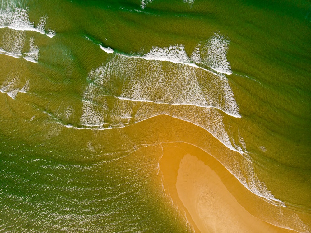 an aerial view of a sandy beach and ocean