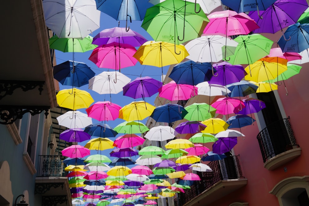 a bunch of colorful umbrellas hanging from the ceiling