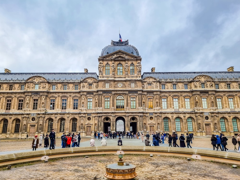 a large building with a fountain in front of it