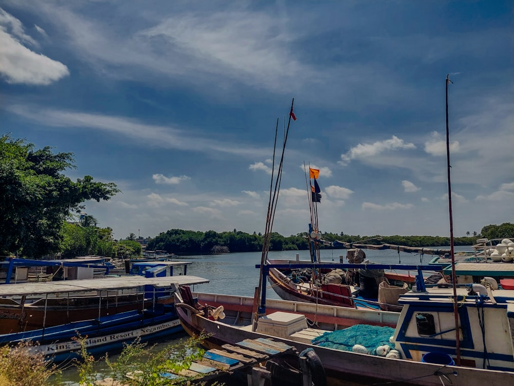 a group of boats sitting next to each other on a river