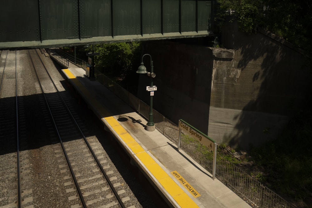 a train traveling down tracks next to a bridge