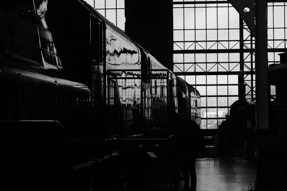 a black and white photo of a train in a train station