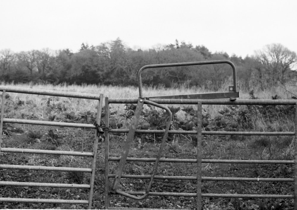 a black and white photo of an old farm equipment