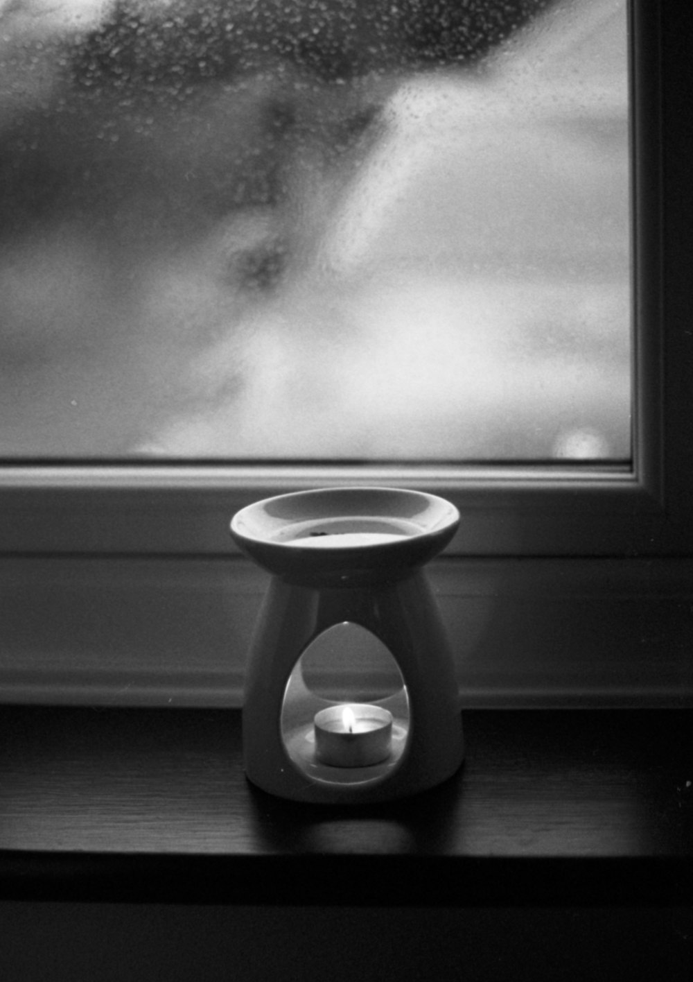 a black and white photo of a window sill
