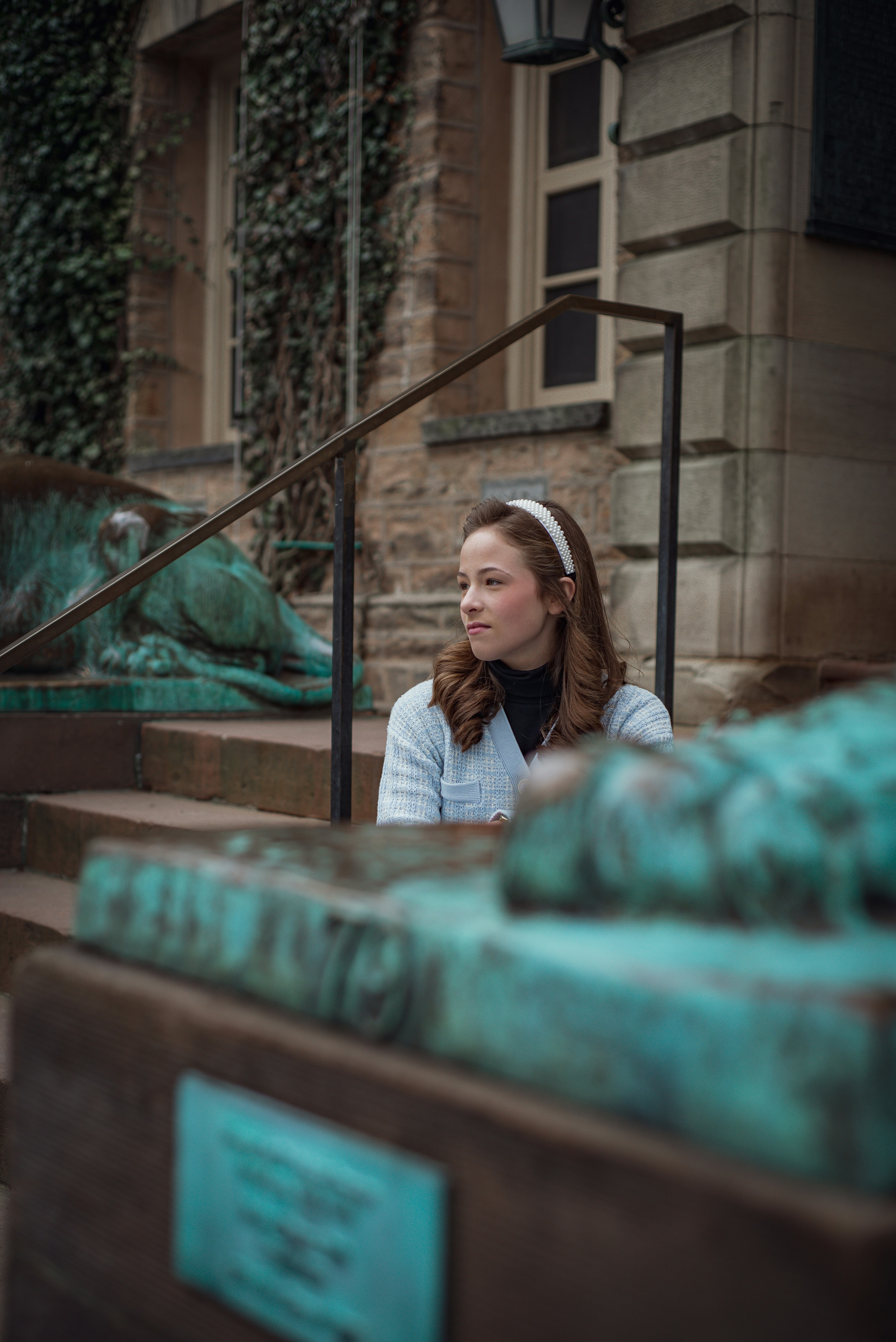 a woman sitting on the steps of a building