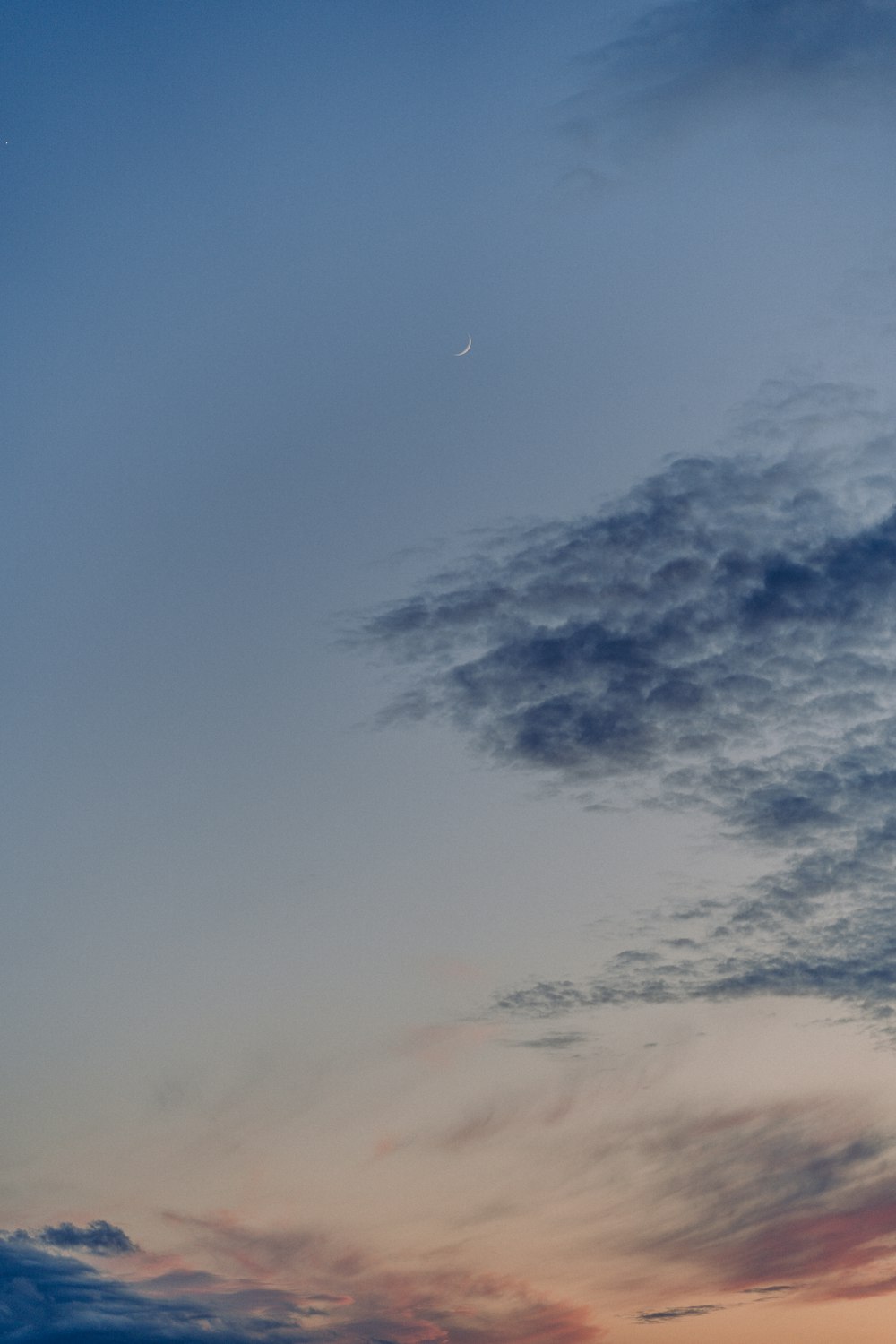 a plane flying in the sky at sunset