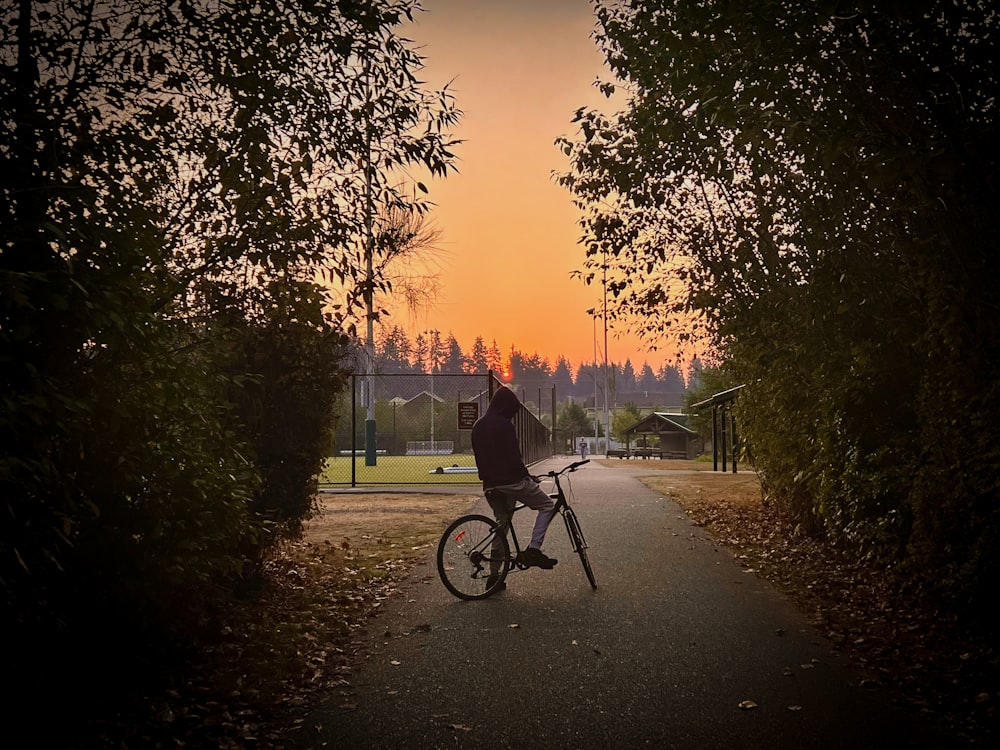 a person riding a bike on a path