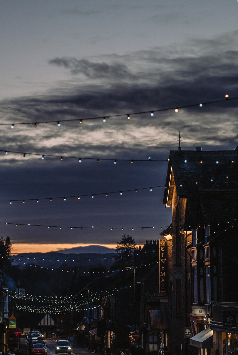 a city street at night with a string of lights