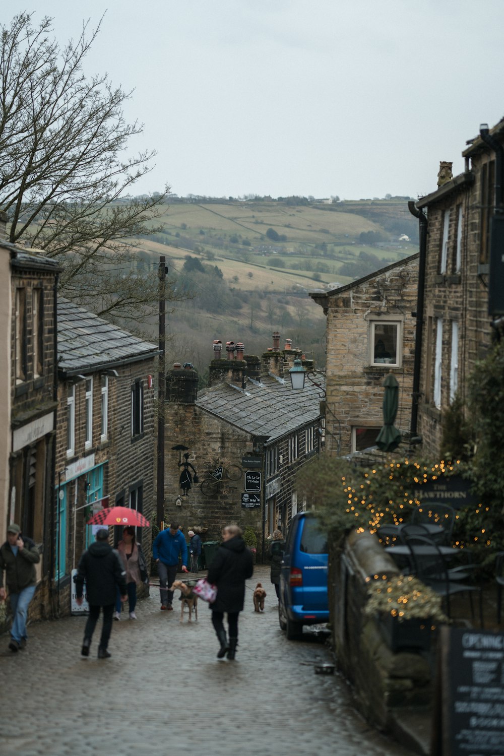 a group of people walking down a cobblestone street