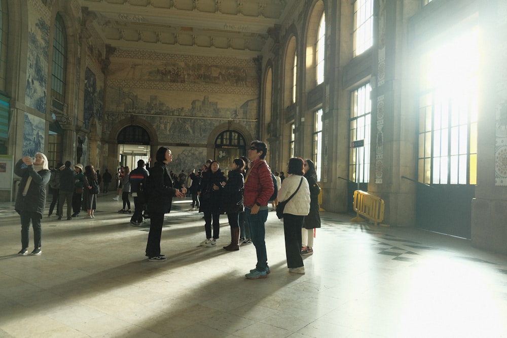 a group of people standing inside of a building