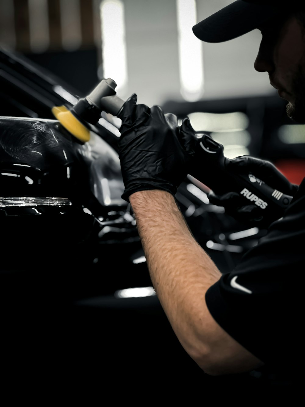 a man working on a car in a garage