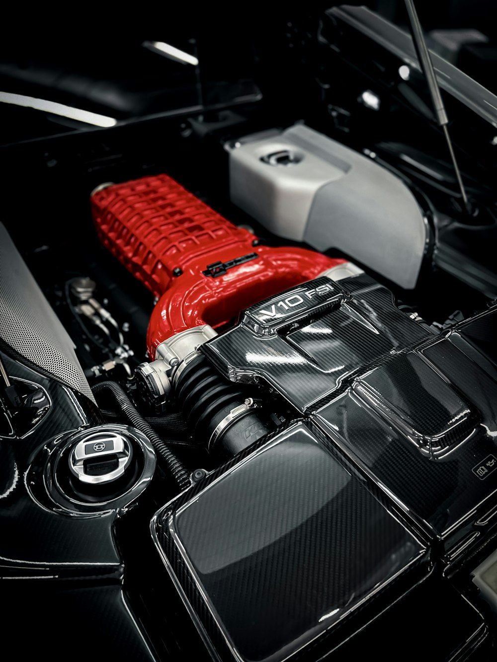 a close up of a car engine with a red engine cover