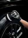 a man with a glove on his hand is changing the tire of a car