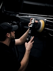 a man is polishing the paint on a vehicle