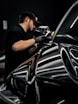a man waxing a car in a garage