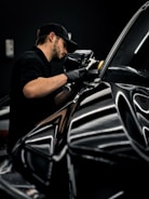 a man waxing a car in a garage