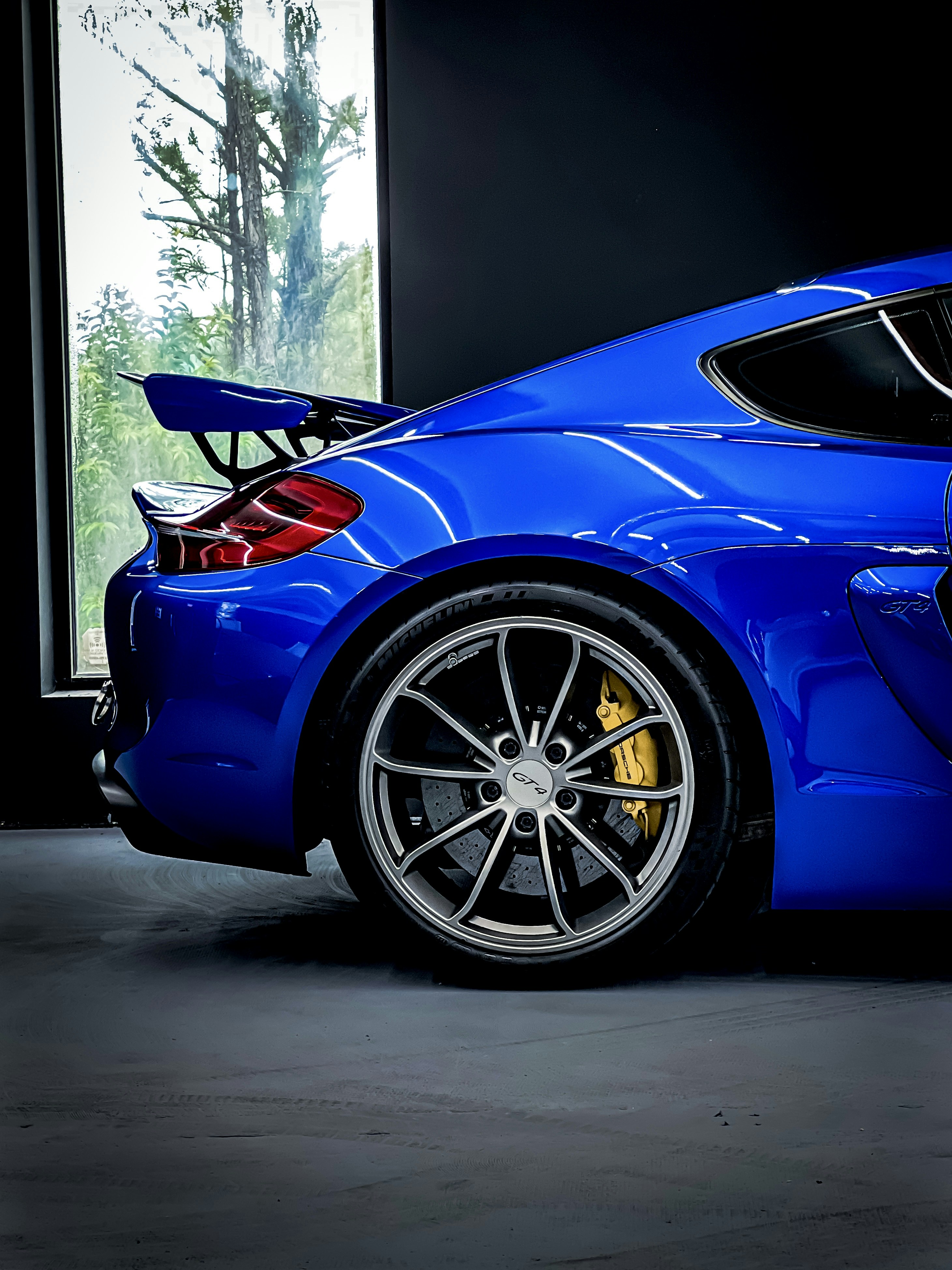 a blue sports car parked in a garage
